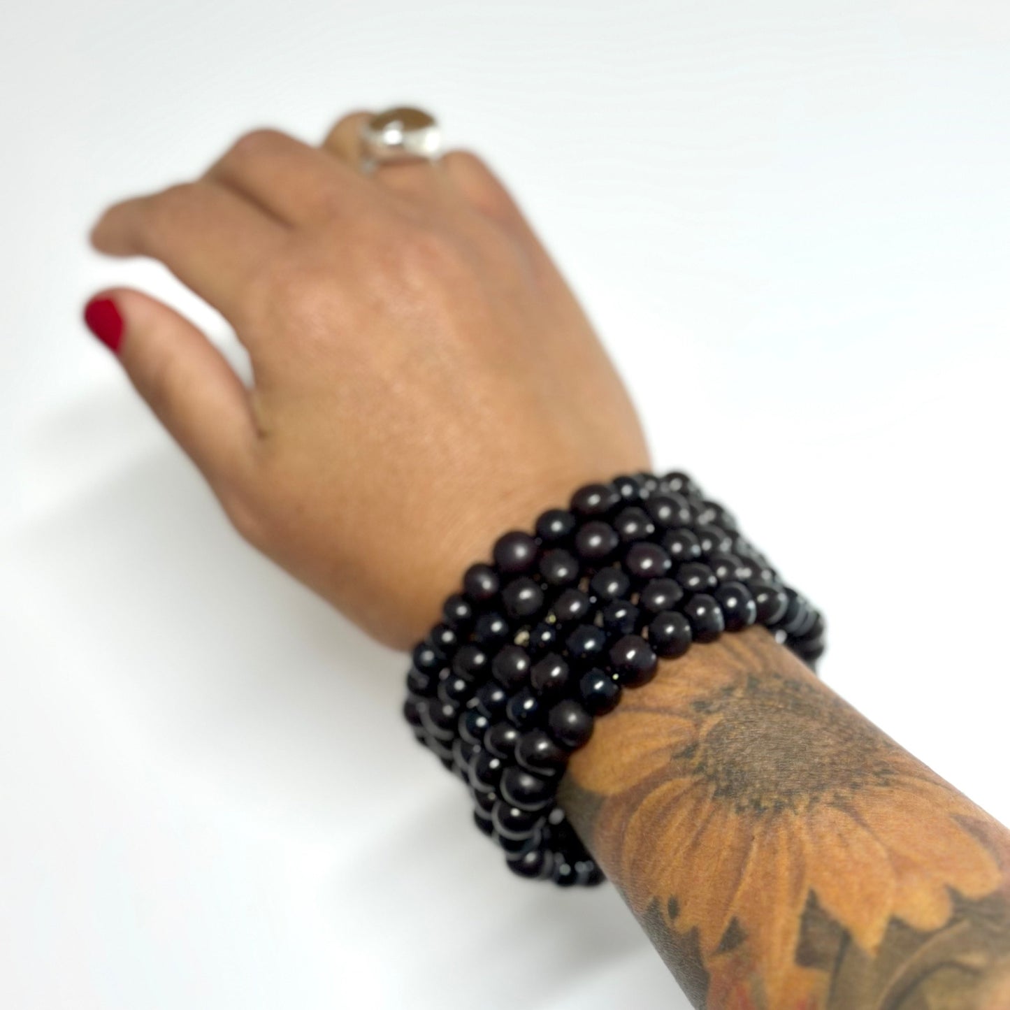 Stylish black Acai Multi Strands Bracelet elegantly adorning a wrist, showcasing the perfect blend of sophistication and eco-friendly fashion. Handmade by artist Fernanda Sullivan in Charleston, SC."