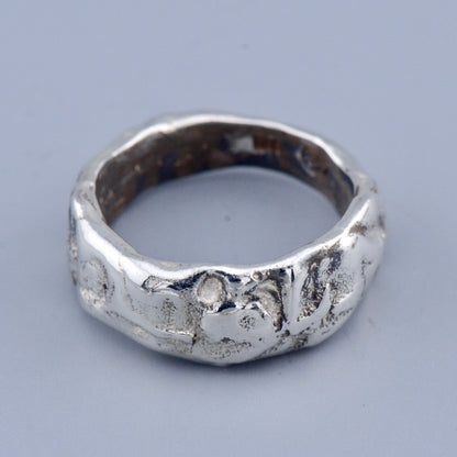 wide erosion ring band on a grey background 